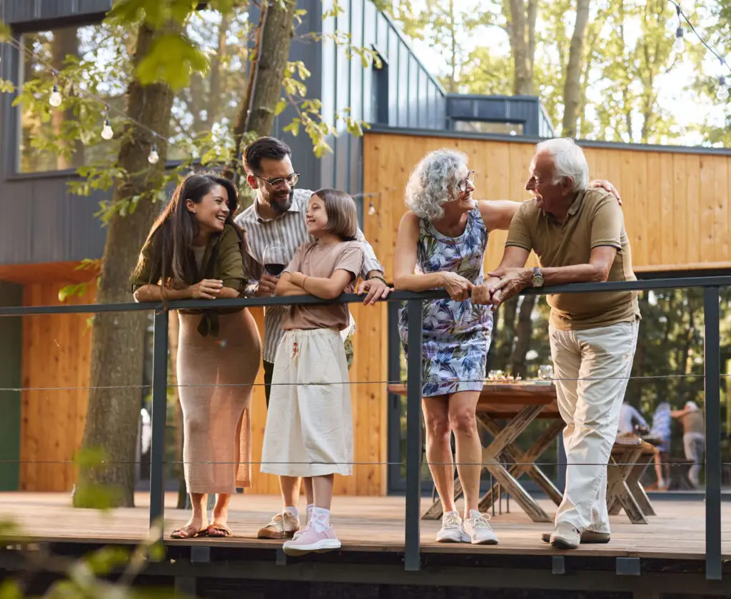Happy multi-generation family communicating while enjoying in spring day on a terrace.